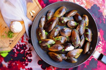 Overhead view of raw mussels with ingredients