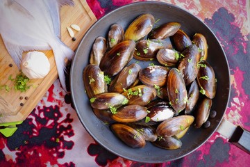 Overhead view of raw mussels with ingredients