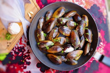 Overhead view of raw mussels with ingredients