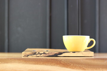 coffee in the morning, cup of cappuccino on wood table in cafe or coffeeshop.