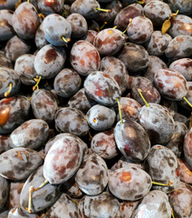 Ripe plum in the store as a background