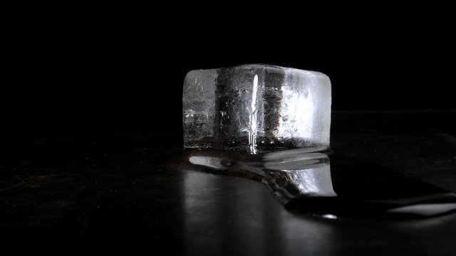 Melting Ice Cube Time Lapse - Isolated on Black Background