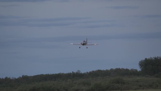 A small homebuilt airplane turns for a low pass at a small airport.