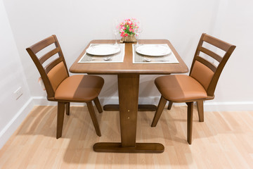 wood dining table set up in a room