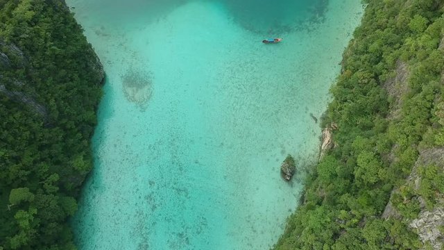 boats over maya bay drone shot above thailands famous maya bay tropical waters