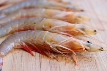 Fresh raw tiger prawns and spices on wooden Background