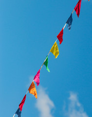 multi-colored flags against a blue sky