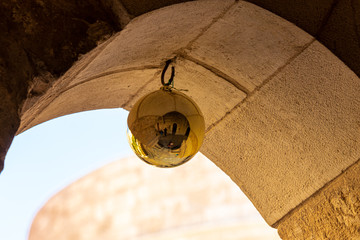 A large gilded ball hangs under the arch in the territory of the Church of Nativity in Bethlehem in...