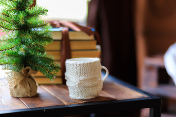 Christmas cup of tea and vintage books on wooden table over beautiful winter bokeh background with copy space - Image