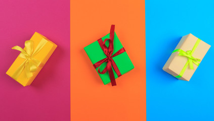 Different colored gift box on color background. Top view of various present boxes on minimal background. Birthday, Christmas, wedding, valentine, romantic gifts - Image