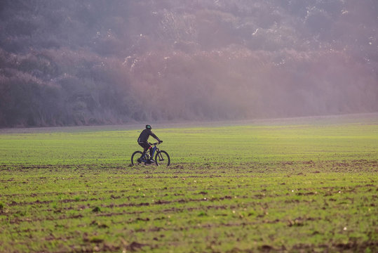 beautiful autumn landscape with a man mountain biking