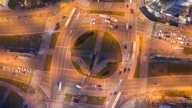 Top-down nighttime view at a huge roundabout in Warsaw, Poland. Lots of traffic, pedestrians. Video with camera motion.