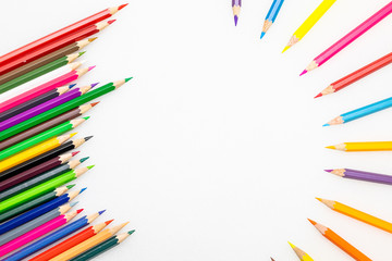 Colour pencils on white background close up