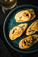 Stewed pear with blue cheese with honey and nuts.