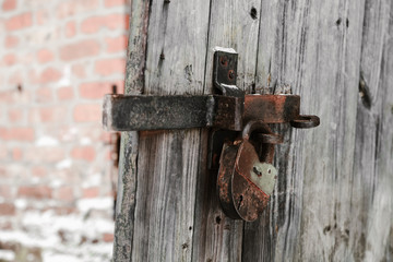 old lock on a wooden door with shallow depth of field