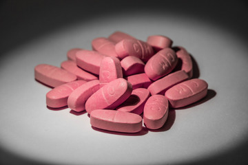 Obraz na płótnie Canvas Close-up photo of some pink pills