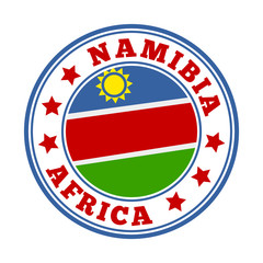 Obraz premium Namibia sign with flag in a round logo. Vector illustration of the national emblem.