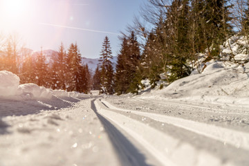 Obraz premium Cross-country skiing in Austria, Hinterthal: Slope, fresh white powder snow and mountains, blurry background