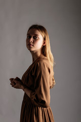 Fototapeta premium Young woman in brown.