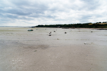The harbour of Cancale with low tide a cloudy day of summer, French Brittany