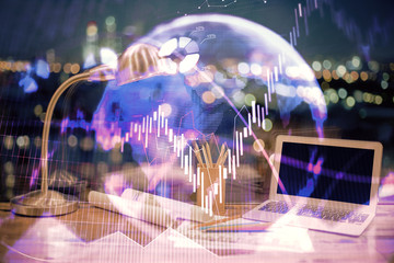 Double exposure of forex chart and work space with computer. Concept of international online trading.