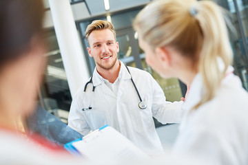Medicine student talks to colleagues