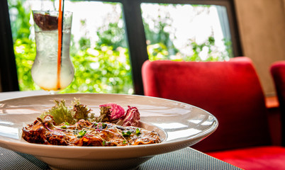 Pasta Lasagna with colorful fresh vegetables on white bowl with blurred background in restaurant