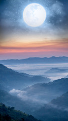 Fullmoon over the foggy mountain