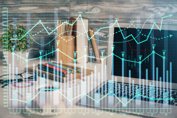 Financial graph colorful drawing and table with computer on background. Double exposure. Concept of international markets.