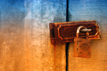 Old wooden doors locked by rusty padlock,iron latch,key lock