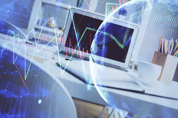 Financial market graph hologram and personal computer on background. Double exposure. Concept of forex.