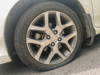 Obraz premium Close up of flat rear tire of a car.