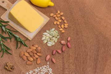 Set of healthy food flat lay. Cheese, almonds, sunflower seeds, walnuts, peanuts, pumpkin seeds. Vegan protein and calcium source.  .