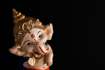 high angle photography of beautiful ganesha statue on black background. culture and hindu concept