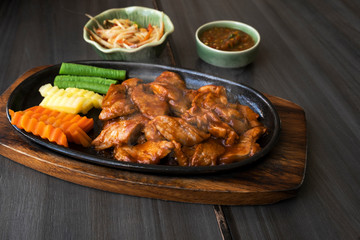 Roast pork with sauce in a hot pan of Thailand