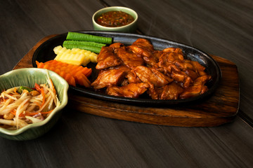 Roast pork with sauce in a hot pan of Thailand