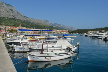 Fototapeta na wymiar Fisherman's boats in wharf in Makarska, Croatia on June 9, 2019.