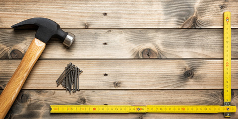 Top view of the hammer and carpenter's work tools on an antique wooden table. Construction...
