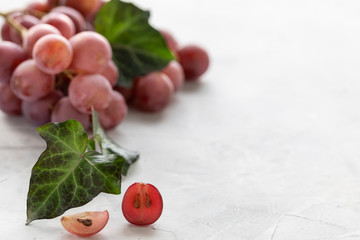 Bunch of red grapes on a white background. Copy space. Place for text.