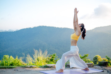 Side view of healthy women practicing yoga. standing in Warrior I pose.asana Anjaneyasana - low...