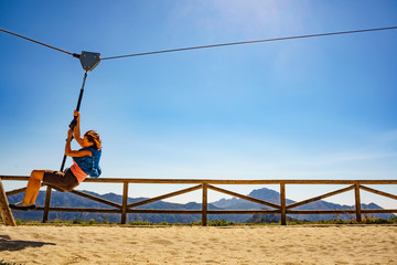 Adult woman having fun on zipline