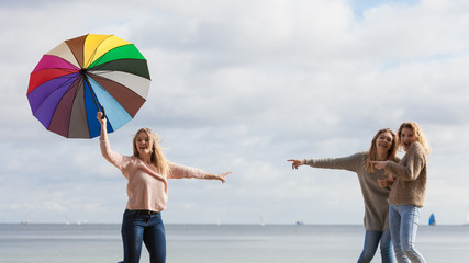 Women making fun of jumping friend