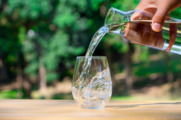 Pouring pure water in to the glass make spread of water crystal bubble with background nature