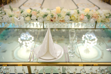 close up photo of arranged presidium table made from glass at a wedding
