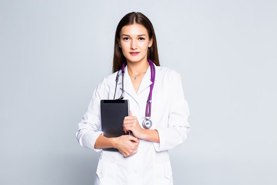 Doctor Using A Tablet Computer Isolated Over A White Background