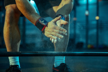 Caucasian man practicing in weightlifting in gym. Close up of male sportive model preparing for training, looks strong. Body building, healthy lifestyle, movement, activity, action concept.