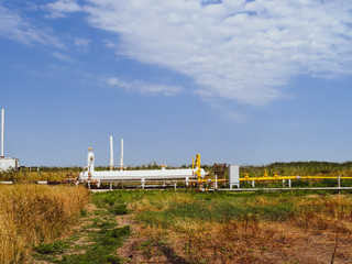 Fototapeta na wymiar Station for preliminary separation and heating of oil emulsion. Equipment at the oil and gas field.