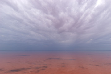 Elton Salt Lake with a pink hue of water and clouds