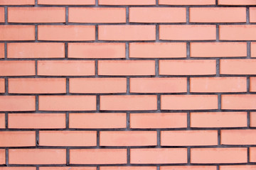 Smooth red brick wall of clay