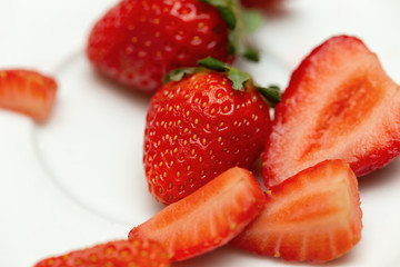 Detail of several strawberries on a plate